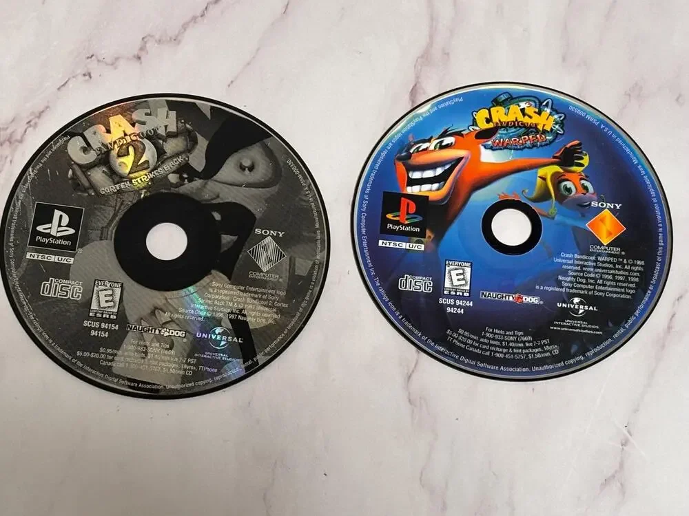 Lot of 2 Play Station 1 PS1 Crash Bandicoot Games Warped Cortex Strikes Back 2